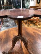 A VICTORIAN MAHOGANY TRIPOD TABLE, THE DISHED PETAL EDGED TOP ON THREE COLUMNS MEETING KNEES OF