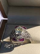 AN OLD CUT DIAMOND AND FANCY CUT RUBY ART DECO STYLE OPEN WORK RING. UNHALLMARKED, STAMPED PLAT,