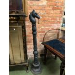 AN ANTIQUE STYLE CAST IRON HORSE TETHERING POST, THE FINIAL AS A HORSES HEAD WITH RING LOOP.