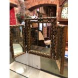 A GILT FRAMED TRIP-TYCH MIRROR WITH MOULDED FRAME