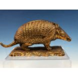 A LATE 19th C. POLISHED BRASS ARMADILLO INKWELL. W 18cms.