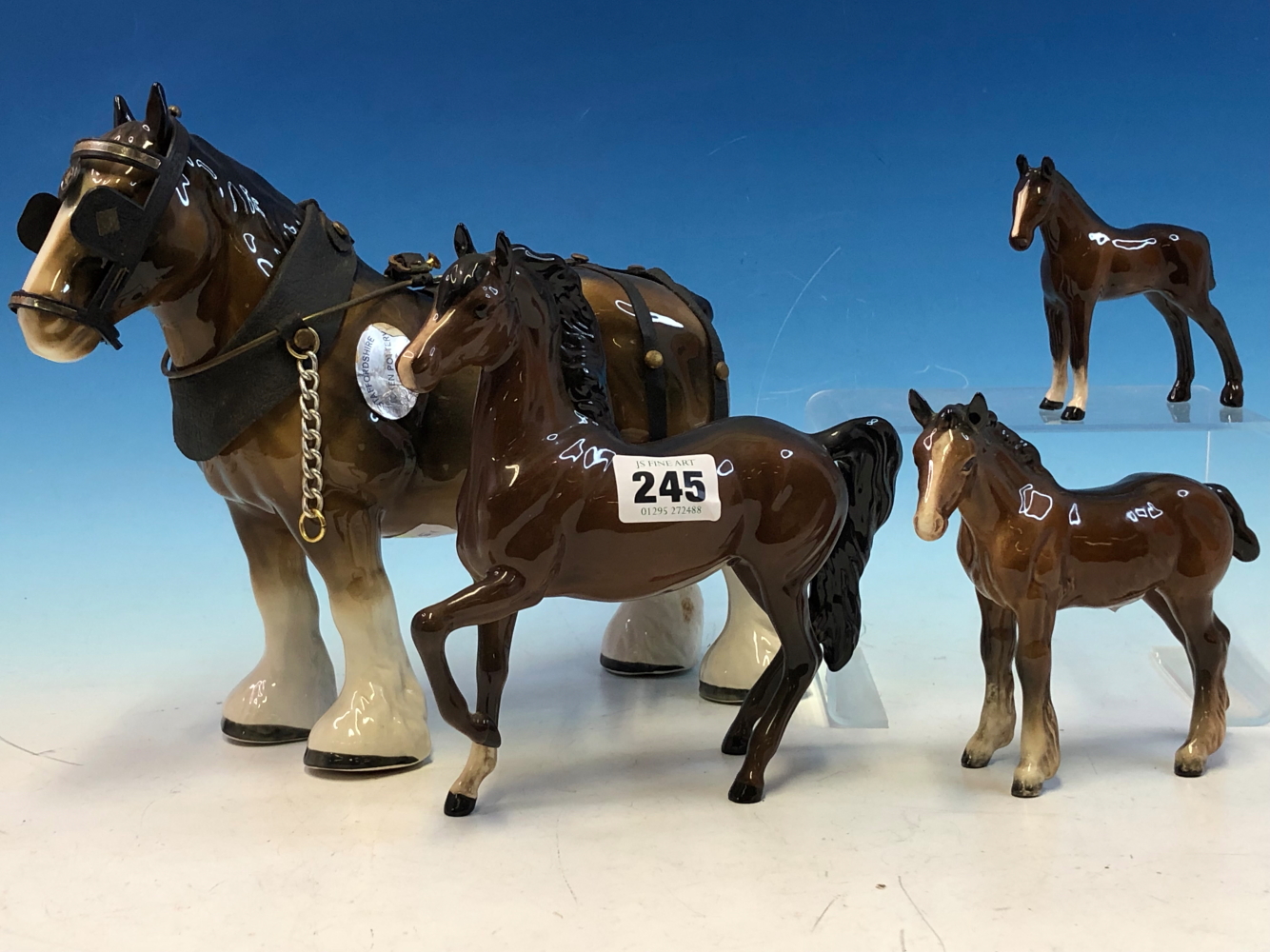 A BESWICK CART HORSE, TWO FOALS TOGETHER WITH A DOULTON BAY HORSE