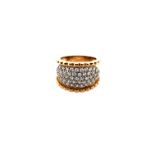 A HALLMARKED 9ct GOLD WIDE TAPERED RING SET WITH FIVE ROWS OF CUBIC ZIRCONIA WITH SHAPED SIDES.