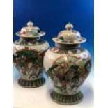 A PAIR OF CHINESE CRACKLE WARE BALUSTER JARS AND COVERS PAINTED WITH WARRIORS ON HORSEBACK AND FOOT.