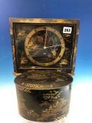 A 1920S SMITHS ELECTRIC CLOCK IN A BLACK CHINOISERIE CASE. W 27cms. TOGETHER WITH A BLACK GROUND