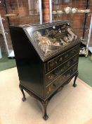 A 1920S BLACK LACQUER GROUND CHINOISERIE BUREAU, THE FALL AND THREE DRAWERS DECORATED WITH ISLAND