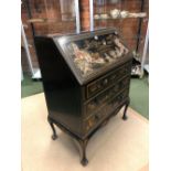 A 1920S BLACK LACQUER GROUND CHINOISERIE BUREAU, THE FALL AND THREE DRAWERS DECORATED WITH ISLAND