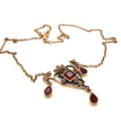 A 9ct HALLMARKED GOLD, GARNET AND SEED PEARL LAVALIERE STYLE NECKLACE. THE HEART FORM PENDANT WITH