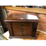 A LATE VICTORIAN MAHOGANY TABLE TOP COLLECTORS CHEST OF FOUR DRAWERS LOCKING BY HINGED PILASTERS