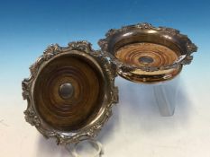 A PAIR OF 19TH CENTURY SILVER PLATED LARGE WINE COASTERS WITH TURNED WOOD BASES