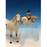 A BESWICK DAPPLED GREY HORSE TOGETHER WITH ANOTHER AFTER THELWELL RIDDEN BY A SMALL GIRL