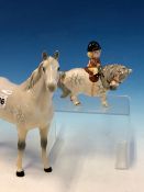 A BESWICK DAPPLED GREY HORSE TOGETHER WITH ANOTHER AFTER THELWELL RIDDEN BY A SMALL GIRL