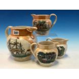 FOUR SUNDERLAND ORANGE LUSTRE JUGS, THE THREE SMALLER JUGS PRINTED WITH FIGURES AND SAYINGS, THE
