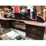 A LATE VICTORIAN MAHOGANY CABINET BACK, THE CENTRAL PALM BUD OVER A BEVELLED GLASS MIRROR FLANKED BY