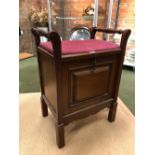 AN EARLY 20th C. MAHOGANY PIANO STOOL WITH HANDLES ON THE NARROW SIDES OF THE RED VELVET SEAT, A