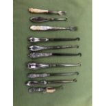 EIGHT VARIOUS SILVER HANDLED BUTTON HOOKS AND TWO M.O.P. HANDLED PICKLE FORKS.