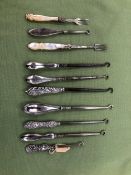 EIGHT VARIOUS SILVER HANDLED BUTTON HOOKS AND TWO M.O.P. HANDLED PICKLE FORKS.