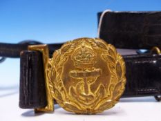 AN EARLY 20TH CENTURY ROYAL NAVY BLACK LEATHER CROSS BELT WITH GILDED CROWN ANCHOR BUCKLE.