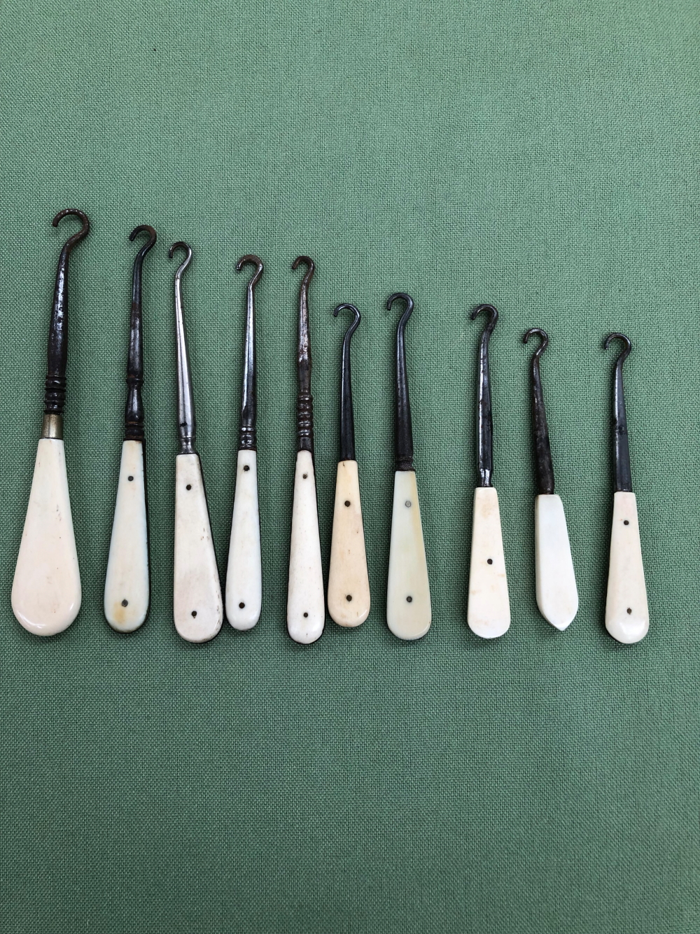 TEN ANTIQUE BUTTON HOOKS WITH BONE AND IVORY HANDLES