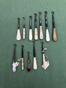 TWELVE ANTIQUE BUTTON HOOKS WITH MOTHER OF PERAL, HARDSTONE BONE AND IVORY HANDLES VARIOUS.