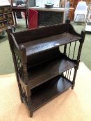 AN EARLY 20th C. EBONISED OAK SET OF THREE WALL SHELVES, THE SUPPORTING COLUMNS BOBBIN TURNED. W