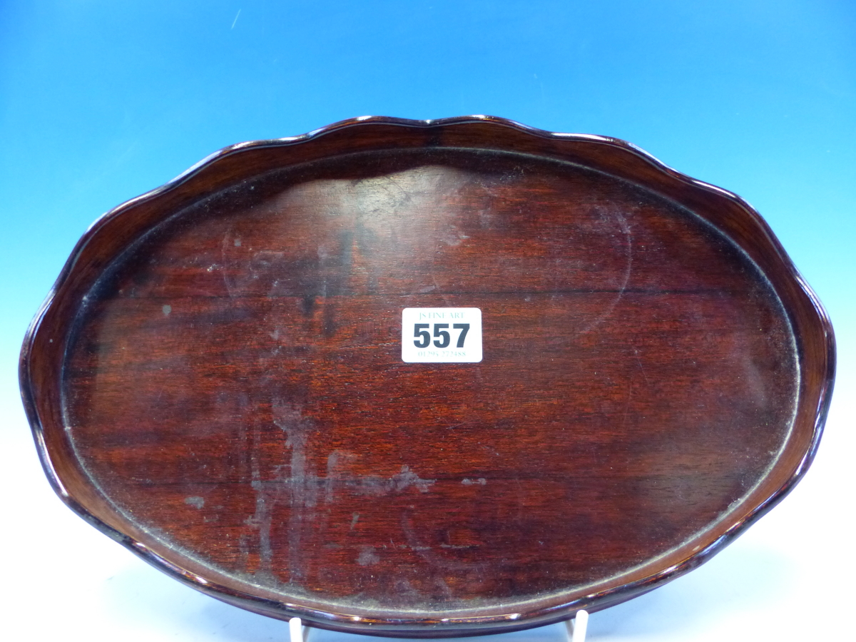 A SMALL MAHOGANY OVAL WINE TRAY WITH WAVY GALLERY EDGE 30CM LONG