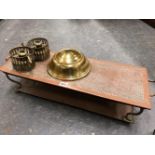 A TWO HANDLED COPPER FOOD WARMING PLATE, TWO BRASS CHAMBER STICKS, A BRASS DOG BOWL AND A CASED PAIR