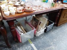 A VICTORIAN MAHOGANY DINING TABLE WINDING OUT TO TAKE A LEAF ABOVE THE REEDED LEGS ON CERAMIC CASTER