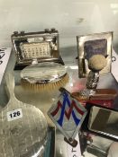 A SILVER MOUNTED CALENDAR, A FRAME, A BRUSH AND HAND MIRROR, A SHAVING BRUSH, ANOTHER BRUSH TOGETHER