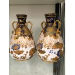 A PAIR OF ROYAL CROWN DERBY GILT DECORATED OVOID VASES.