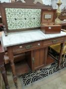 A LATE VICTORIAN TILE BACKED MARBLE TOPPED MAHOGANY WASH STAND WITH TWO DRAWERS ABOVE A CUPBOARD