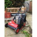 A PETROL SCARRIFIER WITH BRIGGS AND STRATTON ENGINE.