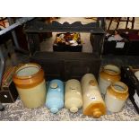 STONEWARE WARMING BOTTLES, A WALL CABINET AND THREE JARS.