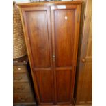 AN EDWARDIAN MAHOGANY CUPBOARD THE TWO PANELLED DOORS ENCLOSING SHELVES. W 61 x D 46 x H 152cms.