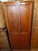 AN EDWARDIAN MAHOGANY CUPBOARD THE TWO PANELLED DOORS ENCLOSING SHELVES. W 61 x D 46 x H 152cms.
