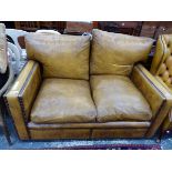 A TWO SEAT SETTEE CLOSE NAIL UPHOLSTERED IN BROWN LEATHER. W 140 x D 100 x H 85cms.