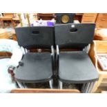 A SET OF ELEVEN 20th C. CHAIRS WITH BLACK PLASTIC BACKS AND SEATS AND TUBULAR METAL LEGS