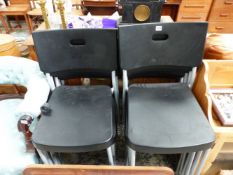 A SET OF ELEVEN 20th C. CHAIRS WITH BLACK PLASTIC BACKS AND SEATS AND TUBULAR METAL LEGS