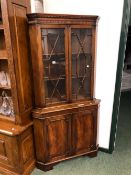 A GEORGIAN STYLE GLAZED CORNER CABINET.