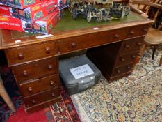 A 20th C. OAK PEDESTAL DESK WITH A GREEN LEATHER INSET TOP OVER A KNEEHOLE DRAWER FLANKED BY BANKS