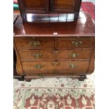 A 19th C. DUTCH MAHOGANY BOMBE BATCHELORS CHEST WITH A WRITING SLIDE ABOVE TWO SHORT AND THREE