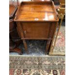 A 19th C. MAHOGANY BEDSIDE CUPBOARD WITH THREE QUARTER GALLERIED TOP AND ON CYLINDRICAL LAGS