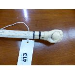 AN ANTIQUE WHALE BONE WALKING CANE WITH IVORY FIST HANDLE. TOGETHR WITH A BOX OF SPILLIKINS