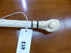 AN ANTIQUE WHALE BONE WALKING CANE WITH IVORY FIST HANDLE. TOGETHR WITH A BOX OF SPILLIKINS