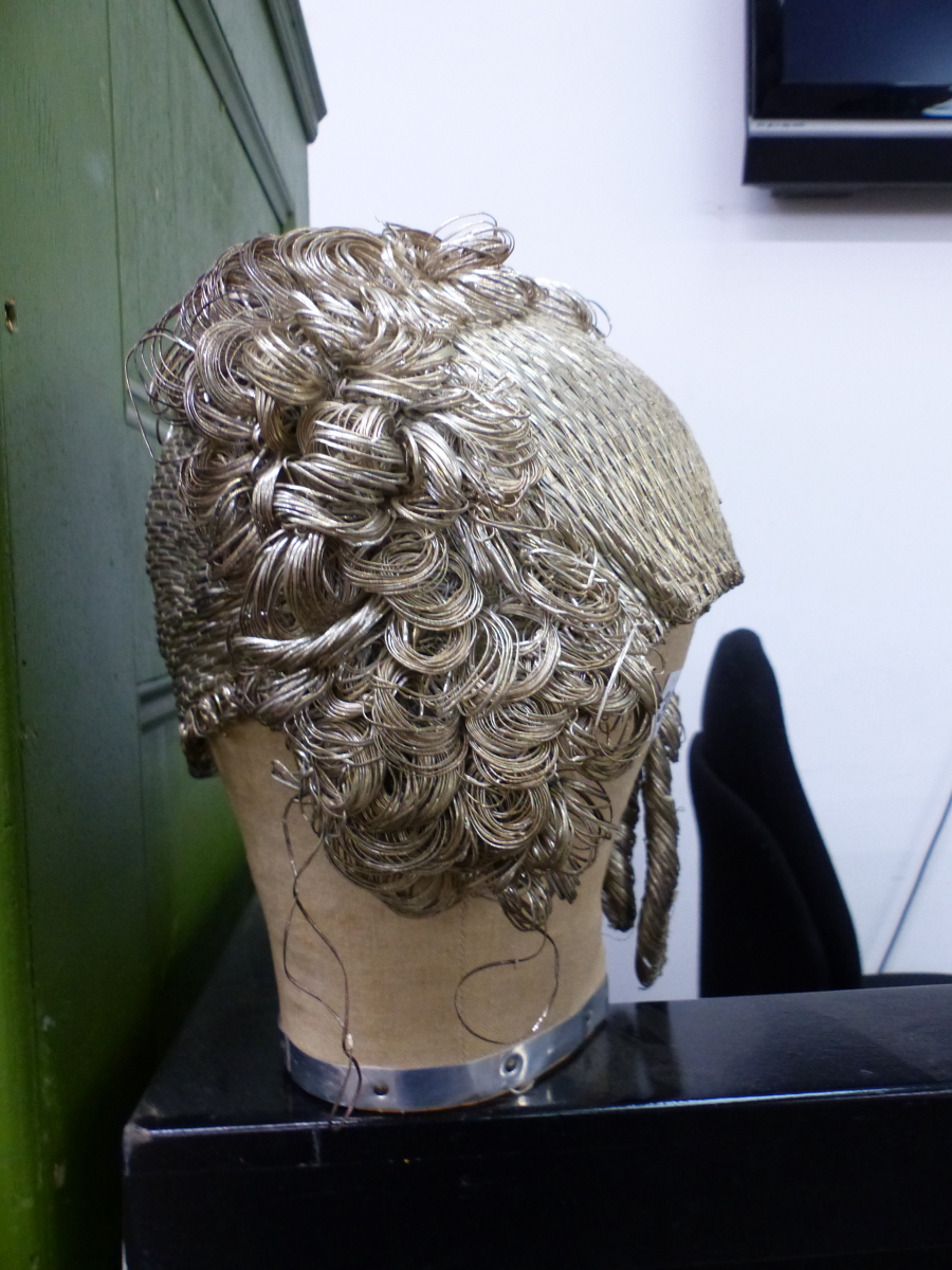 A VINTAGE 1920'S ART DECO FLAPPER METALLIC CLOCHE.