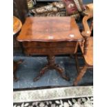 A 19th C. CROSS BANDED MAHOGANY WRITING AND WORK TABLE, THE WAVY EDGED LID OPENING ONTO LIDDED