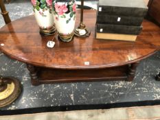 A MODERN STAINED WOOD OVAL COFFEE TABLE ON BALUSTER LEGS JOINED BY A RECTANGULAR TIER. W 150 x D