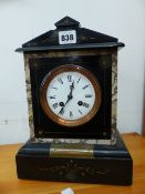 A VICTORIAN BLACK SLATE CASED CLOCK STRIKING ON A COILED ROD