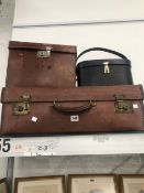 A LEATHER SUITCASE TOGETHER WITH TWO OTHER LEATHER CASES