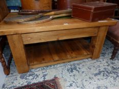 A 20th C. PINE TWO TIER COFFEE TABLE, THE TOP CENTRED BY A RECTANGLE OF GREEN GLASS. W 105 x D 76